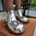 Corten & Stainless Steel Figurative Sculpture – These Boots Are Made for Walking by Nicole Allen, 66x30x40cm on 80x45x45cm Plinth | ARTpark Australia