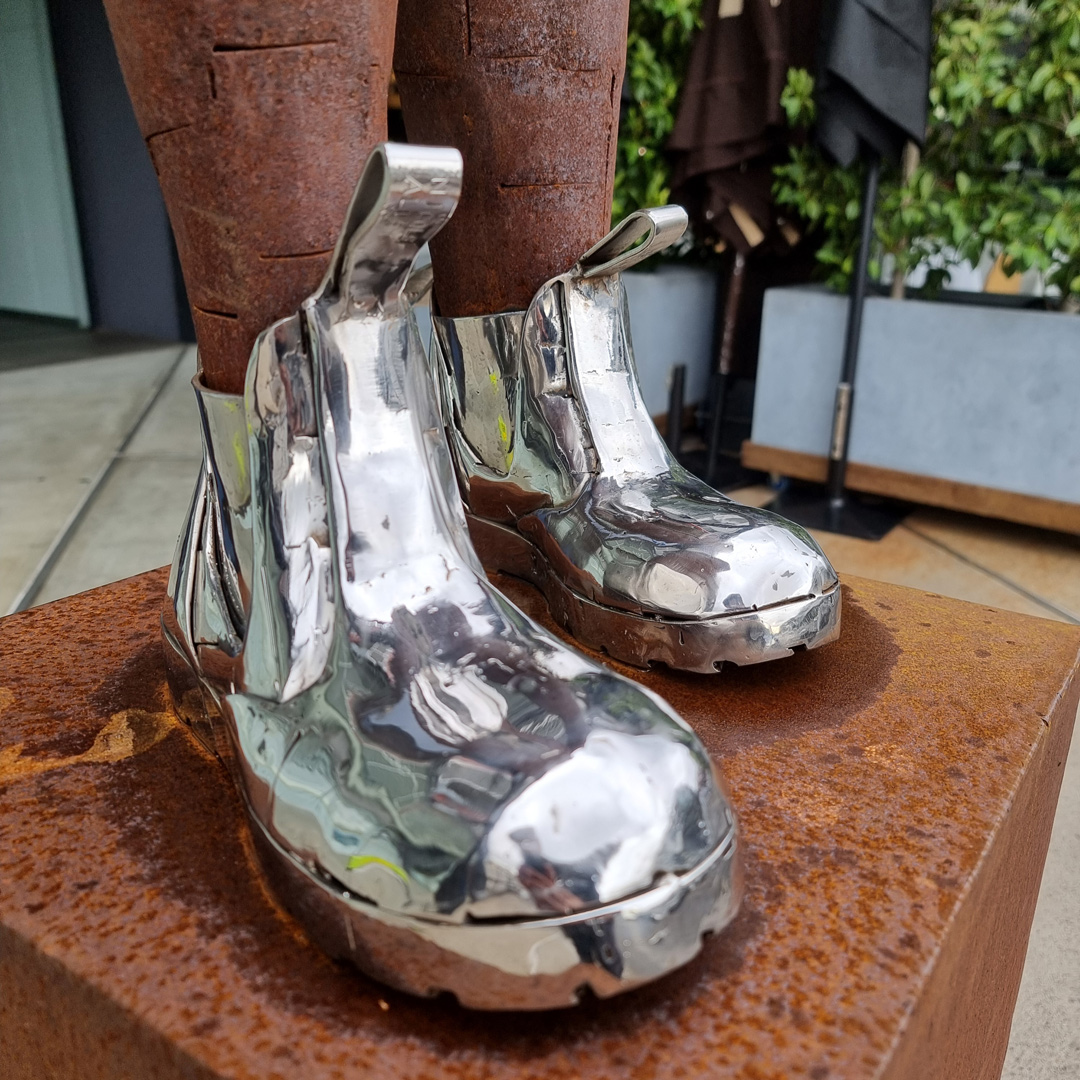 Corten & Stainless Steel Figurative Sculpture – These Boots Are Made for Walking by Nicole Allen, 66x30x40cm on 80x45x45cm Plinth | ARTpark Australia