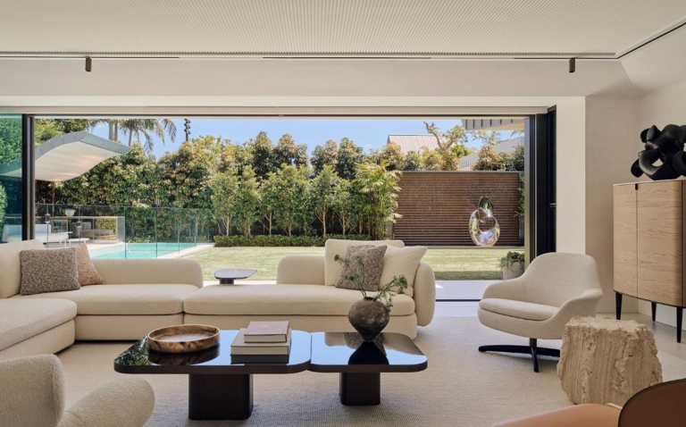 Barda House, Bellevue Hill, built by BAU Group: garden sculpture on a stone plinth with water feature, seen from the living room