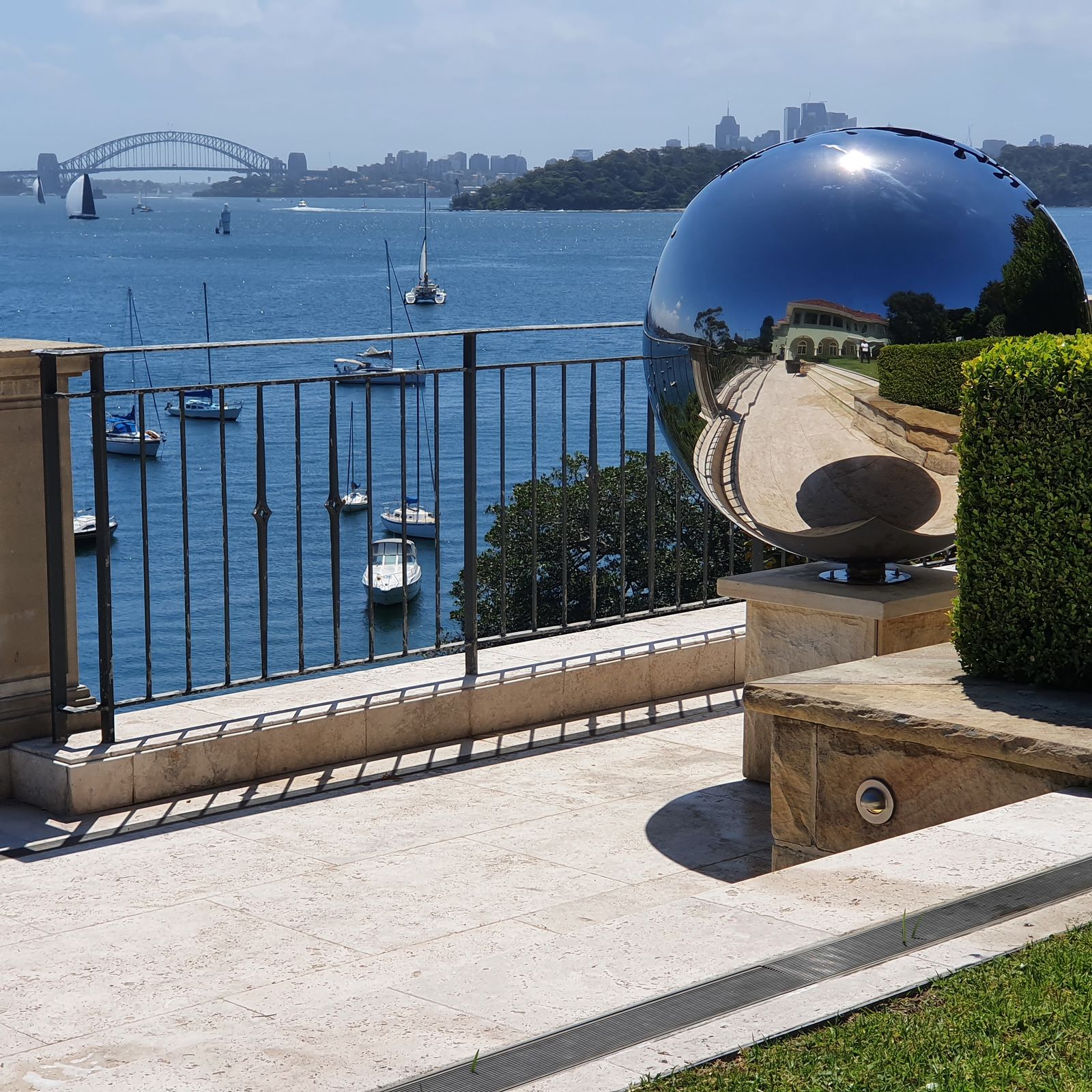 Nice Round Figure by David McCracken, polished stainless steel sphere on a sandstone plinth overlooking Sydney Harbour, Vaucluse