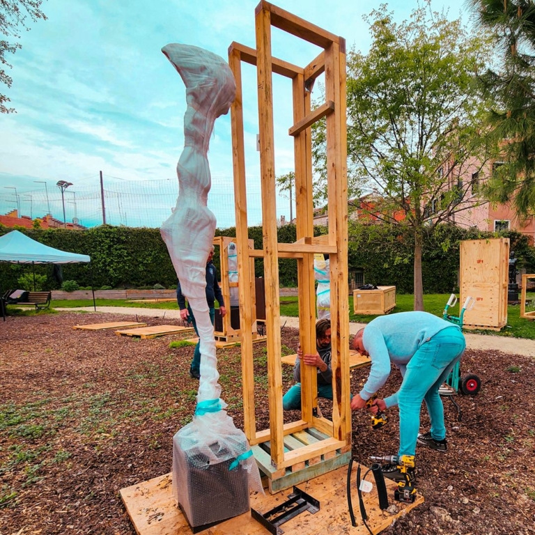 Sculpture being installed on its base inside a timber frame for the Venice 2024 exhibition